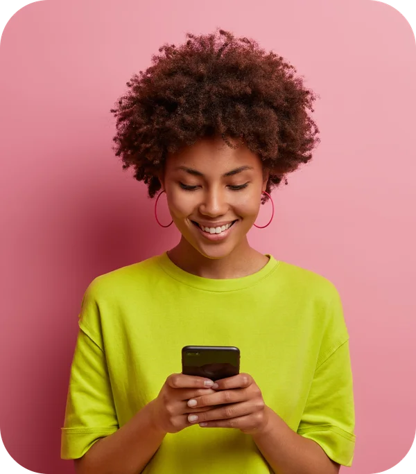 Person smiling and using a smartphone to complete a paid product test