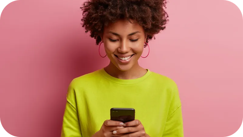 Person smiling and using a smartphone to complete a paid product test