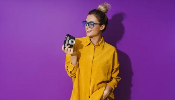 Woman holding a camera representing background and interests on a user testing profile
