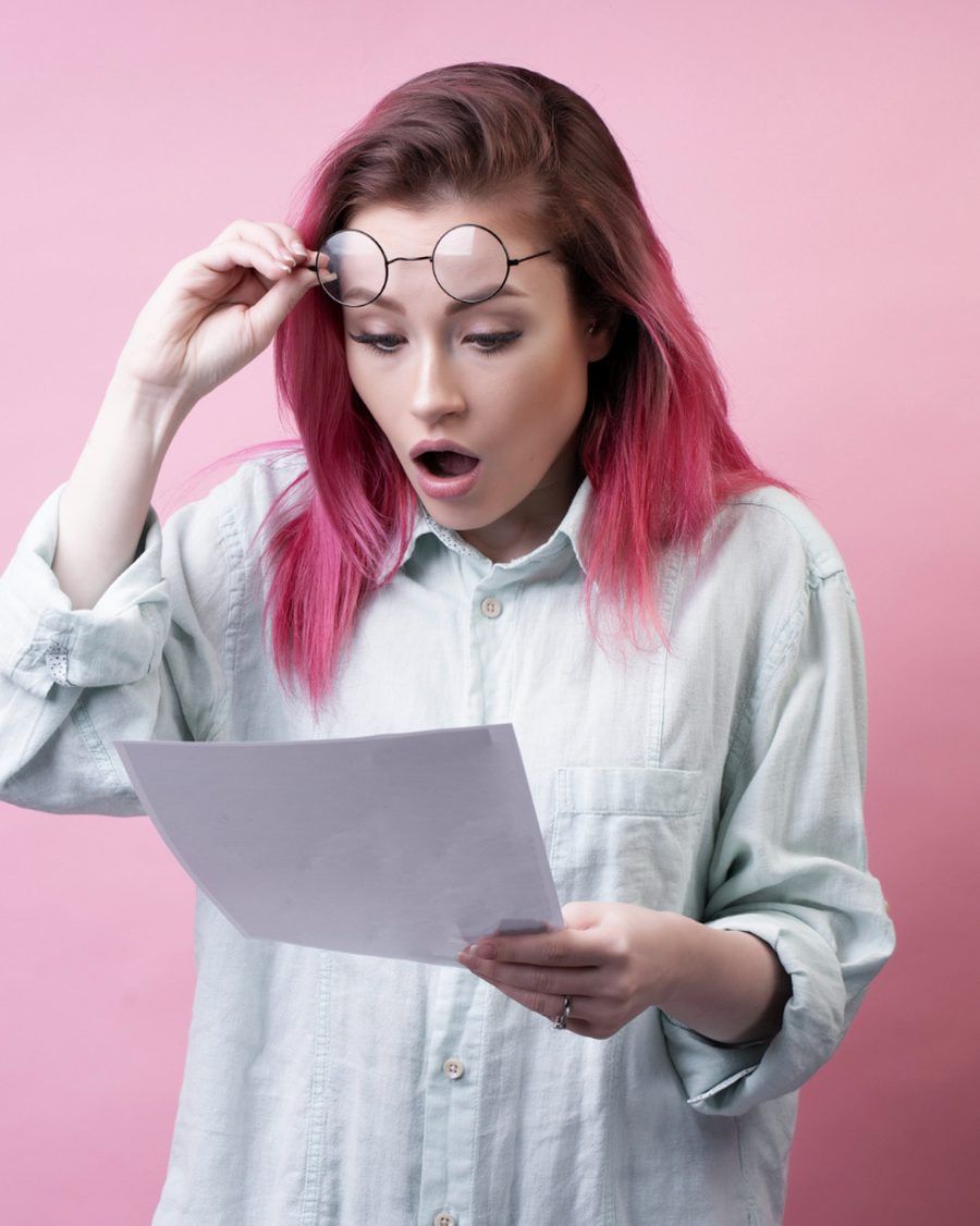 Woman shocked reading a confusing bill — billing comprehension testing