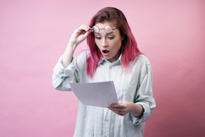 Woman shocked reading a confusing bill — billing comprehension research