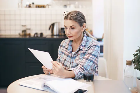 Customer reading a bill at home