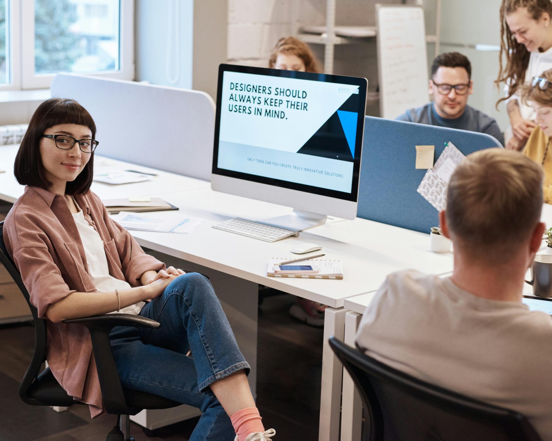 A team of UX designers collaborating in a modern office space, focusing on user-centric design principles.