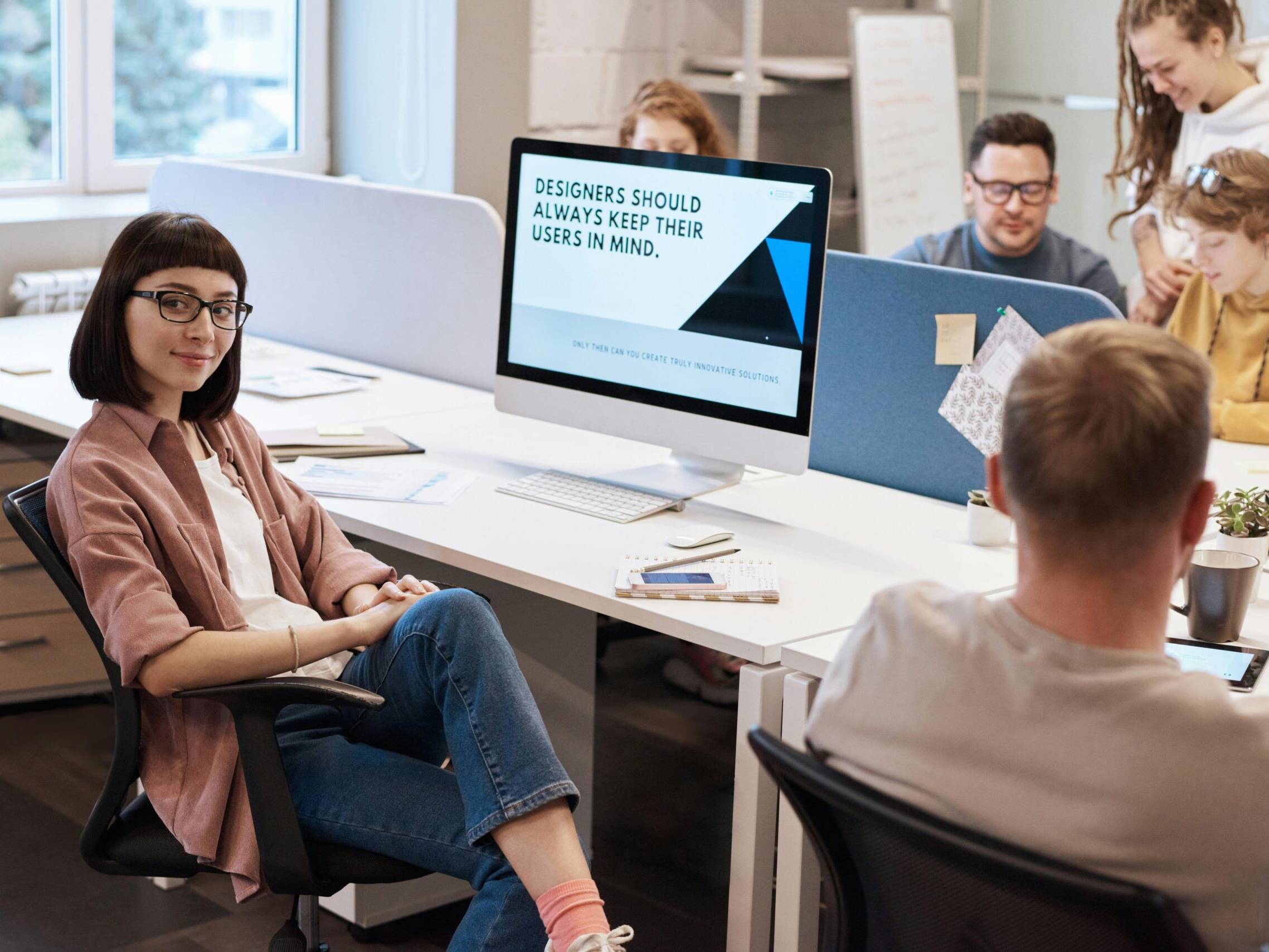 A team of UX designers collaborating in a modern office space, focusing on user-centric design principles.