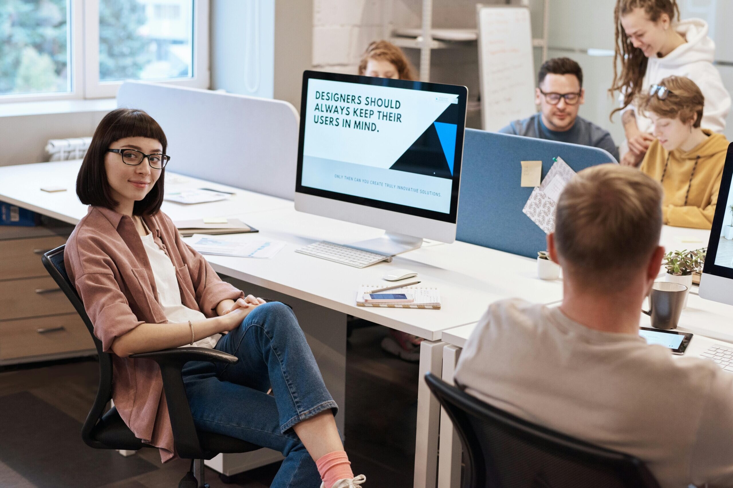 A team of UX designers collaborating in a modern office space, focusing on user-centric design principles.